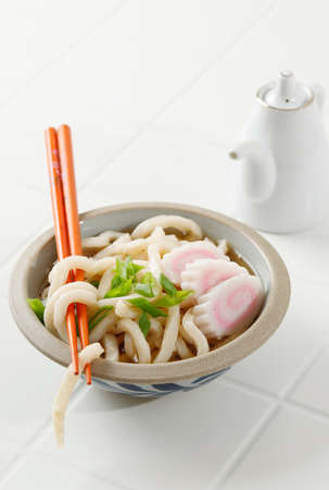Japanese  Udon on Asian Rustic Cement Bowl, on White Tableの写真素材
