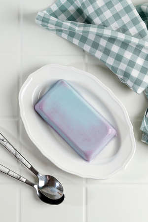 Bubblegum Pudding on White Plate. HOmemade Soft Silky Pudding with Blue Color, Top View