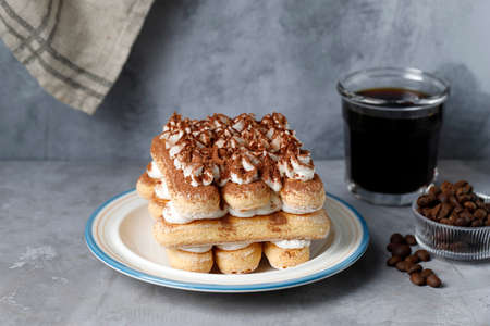 Homemade Tiramisu Cake with A Glass of Black Coffee,  Sweet Italian Dessert. Food Background with...