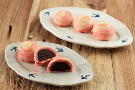 Thousand Layer Mooncake, Pastry Style Mooncakes Filled with Sweetened Bean Paste on Wooden Table