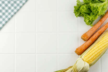Corn, Carrot, and Lettuce over White Background with Copy Space for Text. Diet Concept