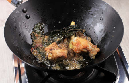 Mix Fried Chicken with Herbs and Spice in a Pan, Cooking Process Making Chicken with Soy Sauce (Ayam Kecap/Semur Ayam)の写真素材