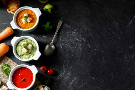 Top View Various Vegetable Soup, Broccoli, Tomato, and, Carrot Soup with Croutons and Bread. Copy Space for Text or Advertisement Conceptの写真素材