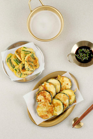 Top View Hobak Jeon and Pajeon, Korean Traditional Vegetable Pancake. Served with Makgeolliの写真素材