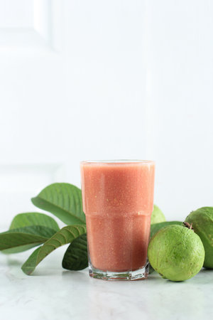 Pink Guava Fresh Juice in a Tall Glass, Isolated on Whiteの写真素材