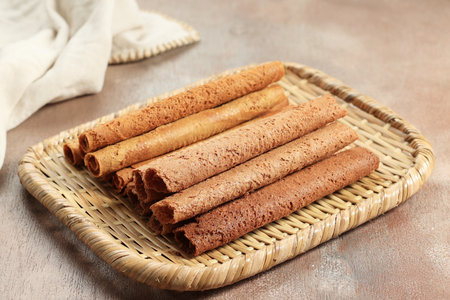 Two Varioua Crispy Egg Rolls or Chinese Waffle Roll on Rattan Plate