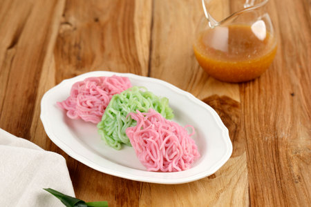 Putu Mayang or Petulo, Indonesian Traditional Snack Made from Rice Flour Strands Curled Up in a Ball, Served with Coconut Milk and Palm Sugar Syrupの写真素材