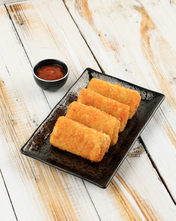 Risoles Ragout Mayo with Chilli Sauce, Indonesian Traditional Savory Snack Filled with Minced Chicken and Mix Cegetable, Coated with Bread Crumb and Deep Fried.の写真素材