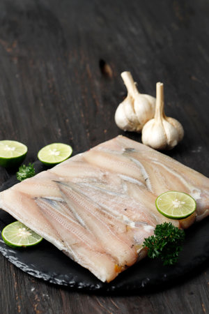 Frozen Catfish Fillet on Black Slate Plate, Fillet Ikan Leleの写真素材