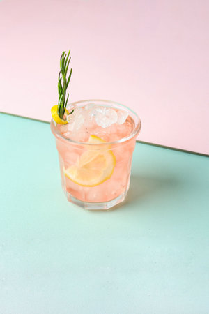 Pink Gin Cocktail with Rosemary on Pastel Backgroundの写真素材