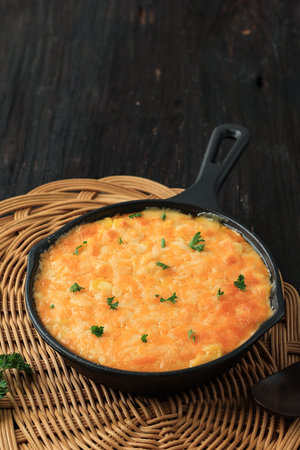 Korean Cheesy Corn on Cast Iron Skillet Pan. Steamed Sweet Buttery Corn with Shredded Cheese Topping. Usually Served for Anju Snack.の写真素材