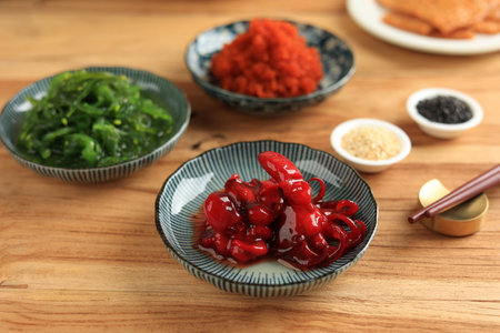 Japanese Food Chinmi Chuka Idako Seasoned Baby Octopus, Closeup on Wooden Tableの写真素材