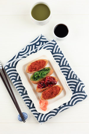 Inarisuzhi, Sushi Pocket with Various Topping. Japanese Food ob White Tableの写真素材