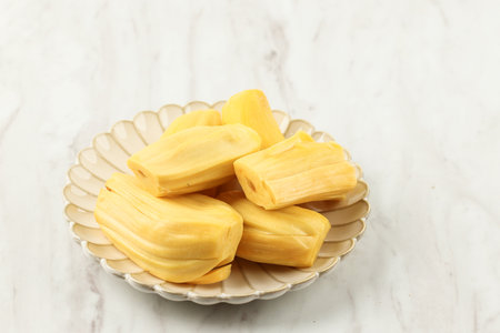 Peeled Fresh and Sweet Jackfruit or Nangka, Served in Ceramic Plate Above White Wooden Marbleの写真素材