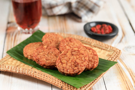 Round Tempeh Goreng or Fried Tempe Served with Sambal and Warm Tea.の写真素材