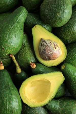 Green Avocado Fresh Picked, Half with Seed. Top View, Food Background