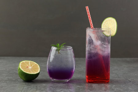 Butterfly Pea Soda with Lemon and Water Melon Juice, on Grey Tableの写真素材