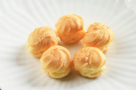 Close Up Profiteroles with Whipped Cream and Chocolate Filling. Kue Sus Mini Choux