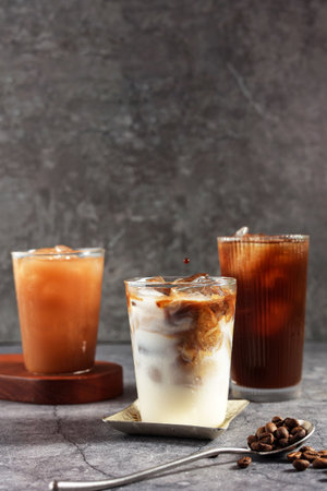 Iced Americano, Iced Coffee Latte, and Ice Thai Tea in Rustic Grey Table with Copy Space for Text