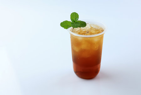 Iced Tea or Es Teh with Mint Leaf Isolated on White Background. Fresh Summer Drinkの写真素材