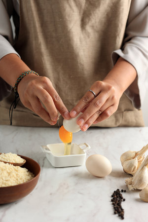 Woman Crack Egg to the Bowl, Cooking or Baking Preparation in the Kitchen