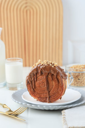 Cromboloni or Crombolini, Croissant Bomboloni Round New York Roll with Chocolate Sauce and Chopped...
