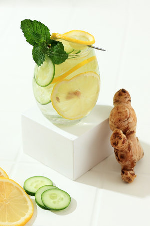 Sashi Healthy Slimming Water. Fresh Cold Water with Sliced Lemon, Cucumber, Ginger, Mint Leaf, and Ice in a Glassの写真素材