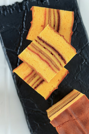 Slice Philipines Layer Cake or Lapis Filipina, Top View on Stone Plates for Imlek Chinese New Year