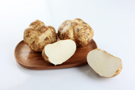 Jicama or Bengkuang on Wooden Plate, White Backgroundの写真素材