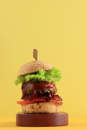 Homemade Mini Burger with Beef Patty on Yellow Backgroundの写真素材