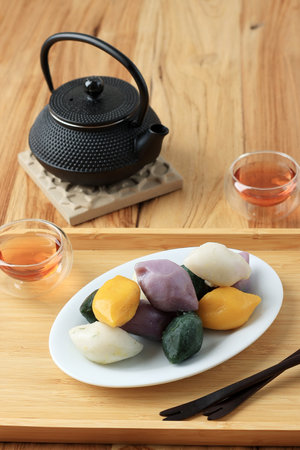 Traditional Chuseok Day Food, Korean Half Moon Shaped Rice Cake or Songpyeon. Made from Korean Rice Flour with Sesame Seed or Chopped Nuts, Honey, or Red Bean Pasteの写真素材