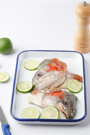 Raw Fish Head with Sliced Lime for Gulai Kepala Ikanの写真素材