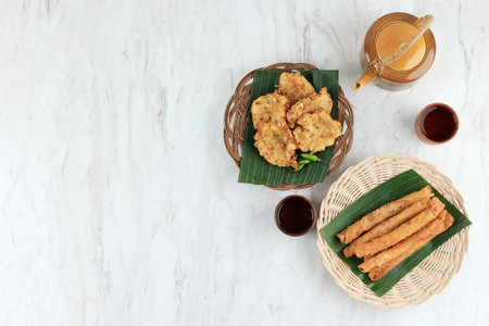 Bala-bala and Pisang Aroma Banana and Vegetable Fritters Served with Hot Teaの写真素材