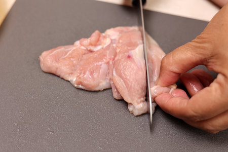 Female Hand Cut Chicken Fillet, Close Upの写真素材