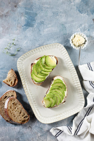 Top View Open Sandwich Sourdough Bread with Sliced Avocado, Cream Cheese, and Honey