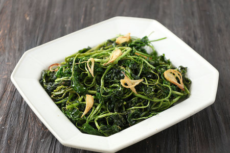 Jukut Goreng or Selada Air Goreng, Deep Fried Watercress with Salt and Friedn Onion. Popular Side Dish in Sundanese Restaurantの写真素材