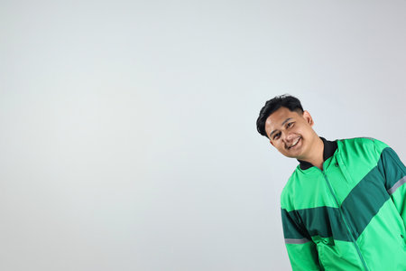 Asian Driver with Uniform Jacket Against White Wall Copy Space for Banner and Ads