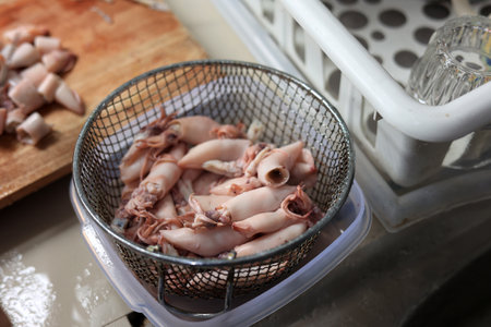Salted Squid or CUmi ASin Drained on Wire Backet after Boil, Step Process before Cookingの写真素材