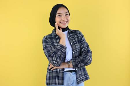 Young Asian Woman Wearing Scarf, Smiling to the Camera with Hand Touching Her Cheek, Isolated on...