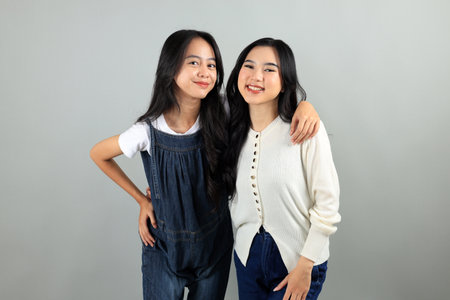 Two Girl Best Friend Hugging Each Other, Positive Cuddles Optimistic Have Fun Trust Each Other. Isolated on grey Studio Backgroundの写真素材
