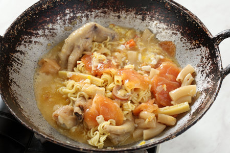 Close Up Pan with Seblak. Making Seblak is Bandung, Popular Street Food Mix Varius Topping like Sausages, Meatball, Noodles, and Crackers.の写真素材