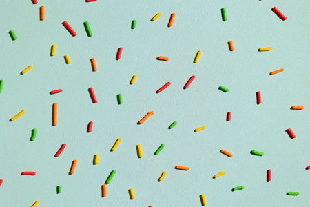 Pattern of Colorful Sprinkles with Hard Shadow on Mint Background, Creative Decoration of Summer Concept for Banner, Poster, Flyer, Cardの写真素材