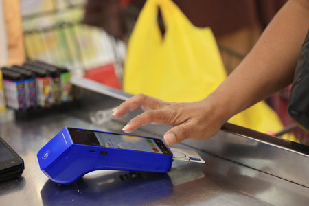 Male Hand Press PIN on EDC Machine on Cashier,  close up of hand entering pin code to card reader terminalの写真素材