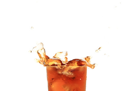 Splash of Iced Tea on Plastic Cup Isolated on White Background. Copy Space for Textの写真素材