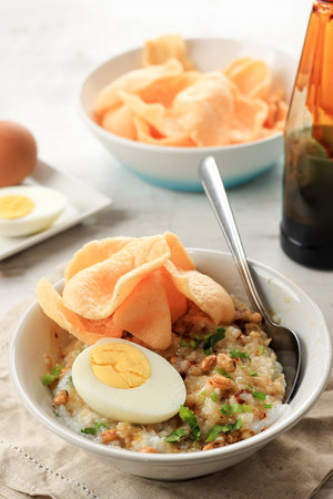 Bubur Ayam Diaduk, Indonesian Rice Chicken Porridge for Breakfast, Served with Stir and Mix all Ingredientsの写真素材