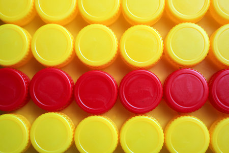 Top View Yellow and Red Plastic Bottle Cup Backgroundの写真素材