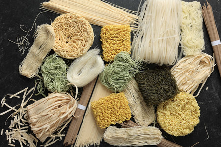 Top View Various Type Raw Asian Dry Noodle, Soba, Ramen, Ramyeon, Misua, Char Kway Teow, Vegetable Egg Noodle, Somen. On Black Marble Tableの写真素材