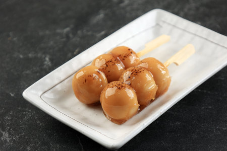 Mitarashi Dango, Japanese Sweet Dumpling in a Sweet Soy Sauce. Served on White Plate