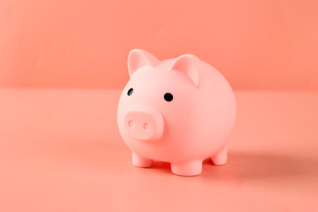 A Pink Piggy Bank on Pink Background with Copy Space for Text