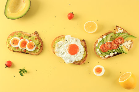 Three Style Avocado Toast on Yellow Background, Healthy Homemade Foodの写真素材